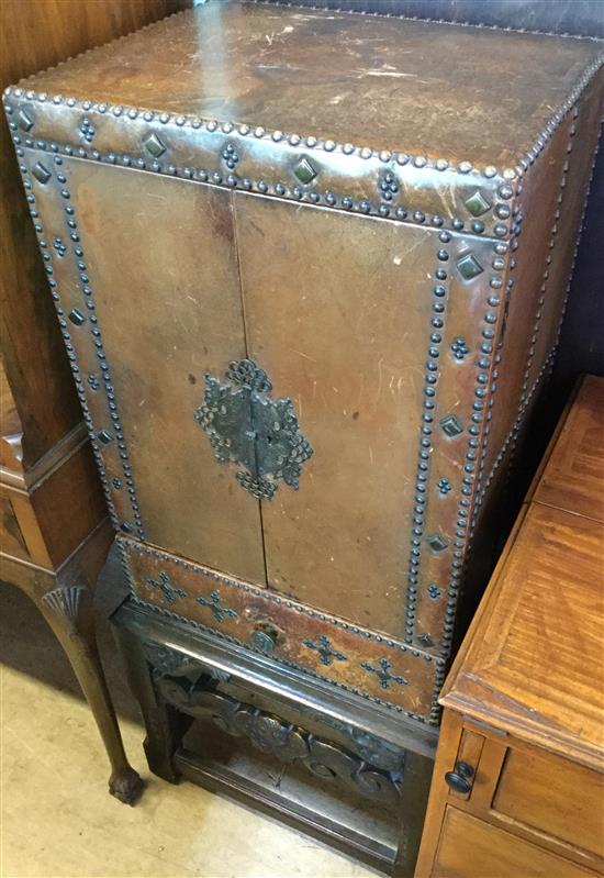 Leather covered cabinet on carved oak base